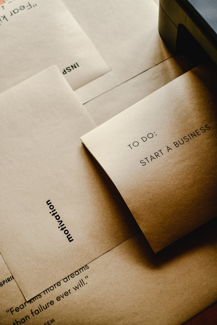 Brown paper envelopes with motivational texts and a to-do list for starting a business.